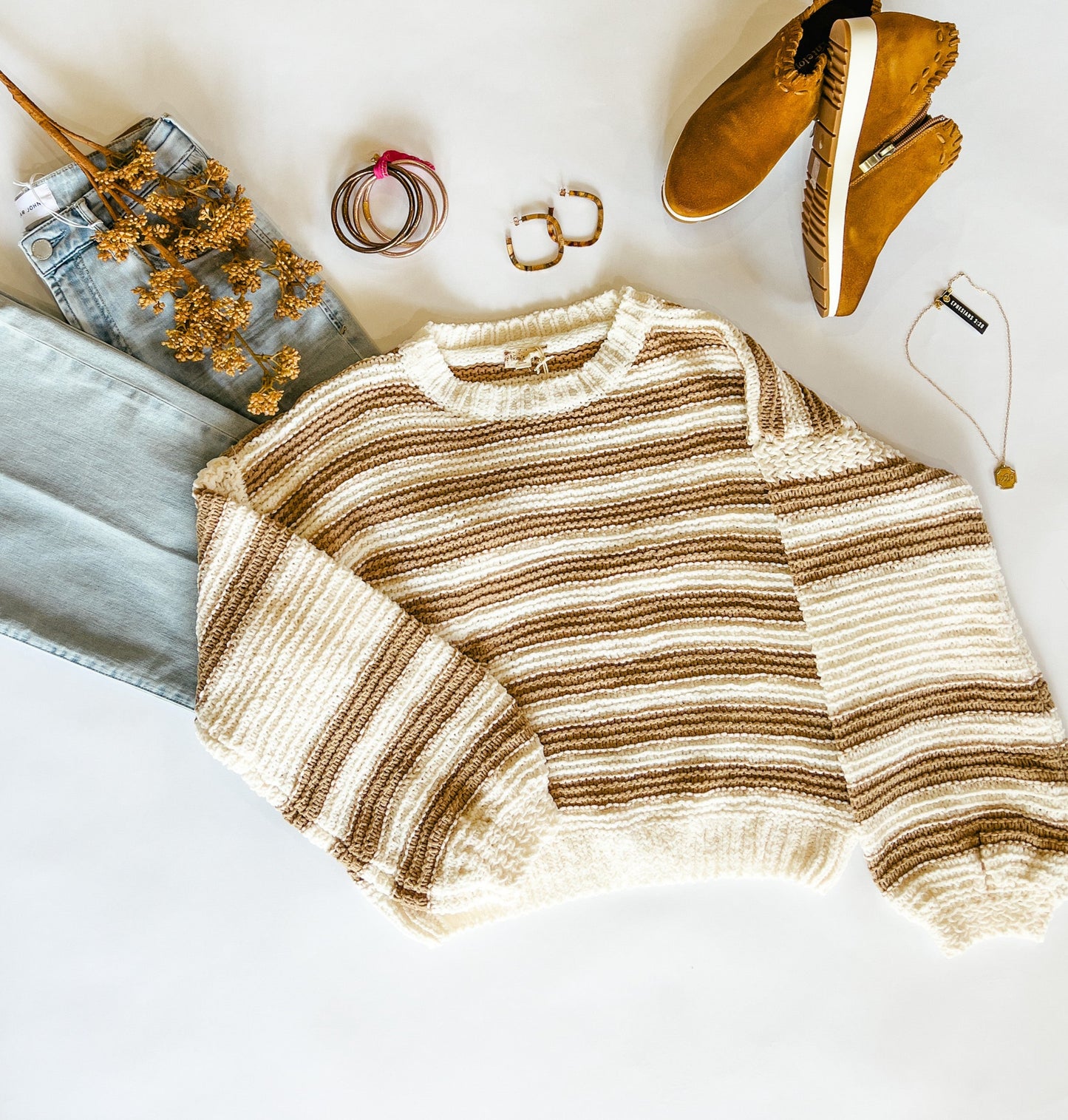 Soft Chenille Sweater in a beautiful monotone stripe. Color: Taupe and Ivory. Long, bubble sleeves, crew neck, waist length.